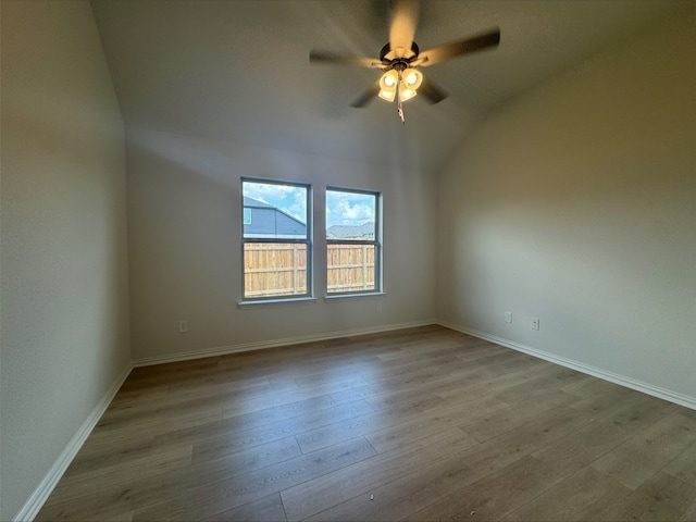 493 Sugar Cane Rd, Buda, TX 78610 - empty room with ceiling fan, wood finished floors, baseboards, and lofted ceiling