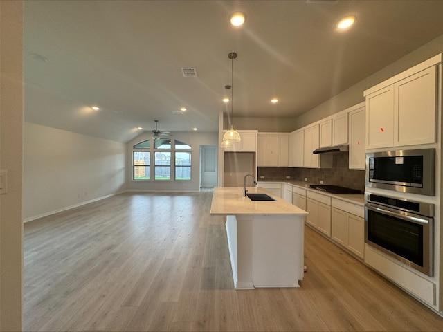 493 Sugar Cane Rd, Buda, TX 78610 - kitchen featuring stainless steel appliances, a sink, decorative backsplash, ceiling fan, and white cabinets