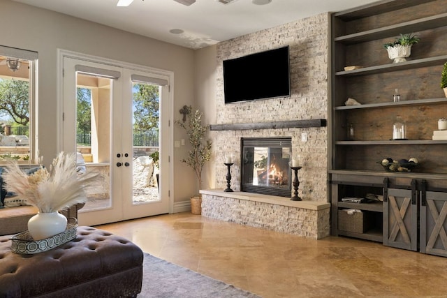 1306 High Lonesome, Leander, TX 78641 - living room with tile patterned flooring, a ceiling fan, a stone fireplace, and french doors