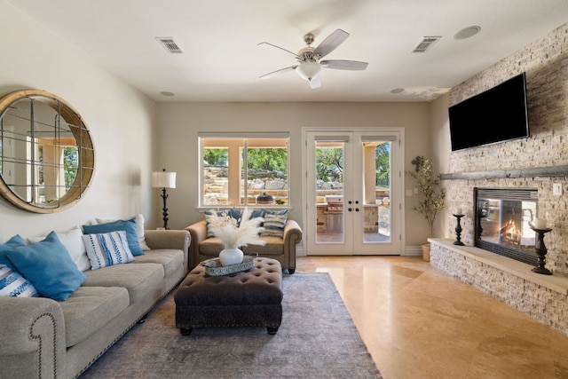 1306 High Lonesome, Leander, TX 78641 - living room with ceiling fan, french doors, and a stone fireplace