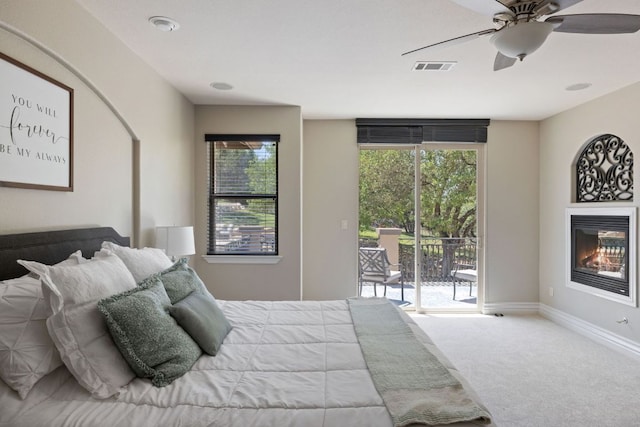 1306 High Lonesome, Leander, TX 78641 - carpeted bedroom with access to outside, a glass covered fireplace, ceiling fan, and baseboards