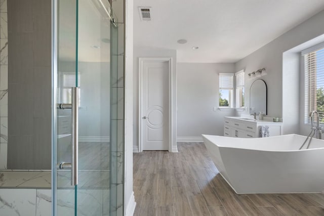 1306 High Lonesome, Leander, TX 78641 - full bath featuring a freestanding tub, vanity, a shower stall, and baseboards