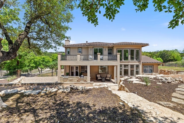 1306 High Lonesome, Leander, TX 78641 - back of property featuring stucco siding, a chimney, a patio, and outdoor lounge area