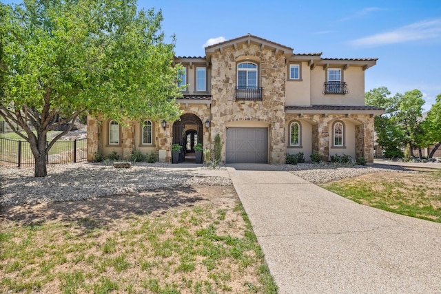 1306 High Lonesome, Leander, TX 78641 - mediterranean / spanish home featuring stone siding, driveway, a tile roof, a garage, and stucco siding