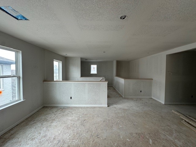 12402 Purple Prairie Ln, Buda, TX 78610 - carpeted empty room with baseboards and a textured ceiling