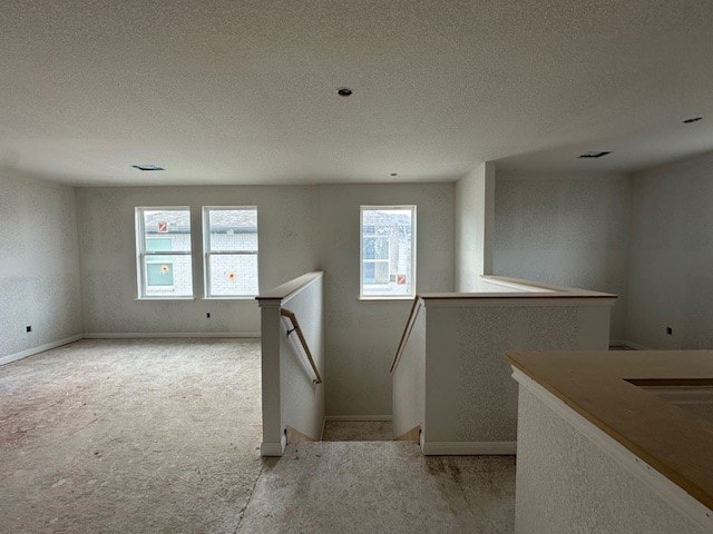 12402 Purple Prairie Ln, Buda, TX 78610 - interior space with a textured ceiling, baseboards, and carpet