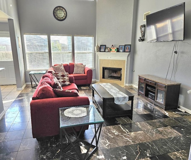 14400 Little Eagle Ct, Elgin, TX 78621 - living area with a tiled fireplace, visible vents, and baseboards