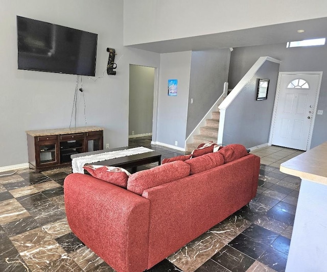 14400 Little Eagle Ct, Elgin, TX 78621 - living area with baseboards, a towering ceiling, and stairs