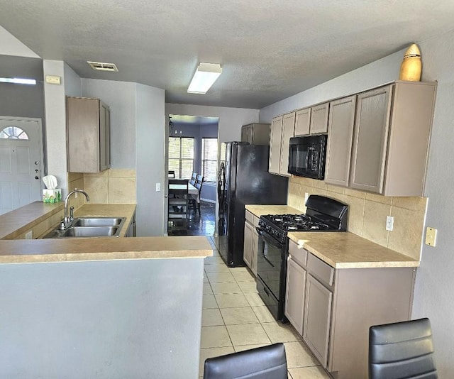 14400 Little Eagle Ct, Elgin, TX 78621 - kitchen with a sink, visible vents, decorative backsplash, and black appliances