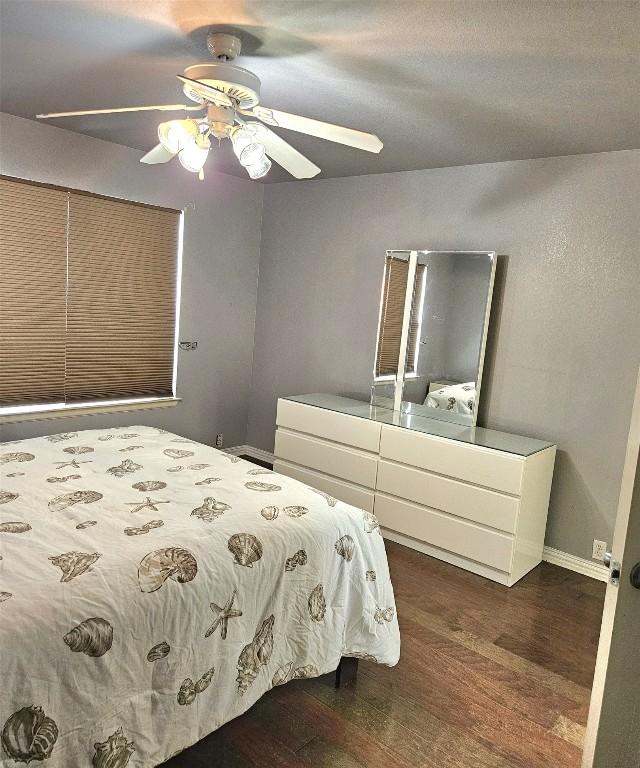 14400 Little Eagle Ct, Elgin, TX 78621 - bedroom featuring a ceiling fan, baseboards, and dark wood-style floors