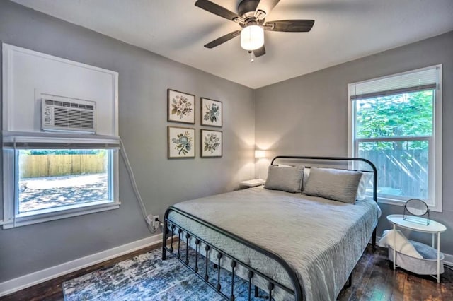 1026 Haynes St Unit 28, San Marcos, TX 78666 - bedroom with wood finished floors, a ceiling fan, and a wall mounted AC