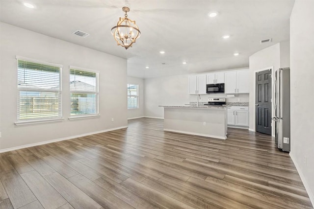8516 Cantera Ridge Rd, Temple, TX 76502 - kitchen with a chandelier, open floor plan, appliances with stainless steel finishes, wood finished floors, and recessed lighting
