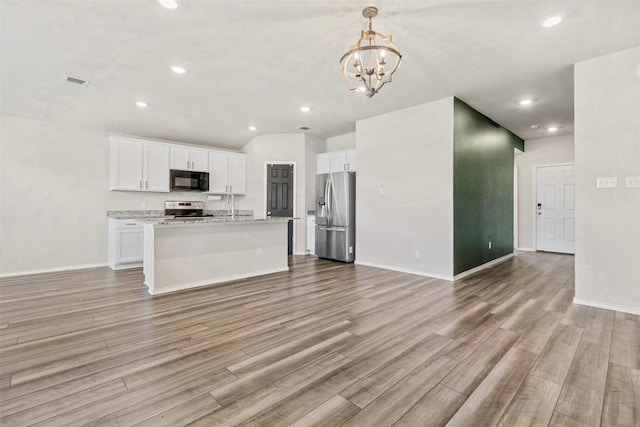 8516 Cantera Ridge Rd, Temple, TX 76502 - kitchen with appliances with stainless steel finishes, open floor plan, a chandelier, light wood-style floors, and recessed lighting