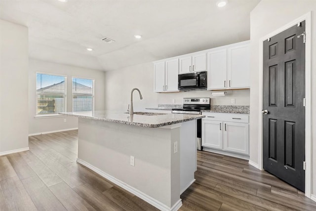 8516 Cantera Ridge Rd, Temple, TX 76502 - kitchen with black microwave, electric range, light stone counters, dark wood finished floors, and recessed lighting