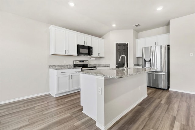 8516 Cantera Ridge Rd, Temple, TX 76502 - kitchen with appliances with stainless steel finishes, light wood-style floors, a center island with sink, recessed lighting, and light stone counters