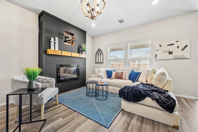 8516 Cantera Ridge Rd, Temple, TX 76502 - living room featuring wood finished floors, a fireplace, recessed lighting, and a chandelier