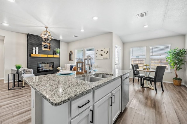 8516 Cantera Ridge Rd, Temple, TX 76502 - kitchen featuring dishwasher, an island with sink, a large fireplace, light wood-type flooring, and recessed lighting