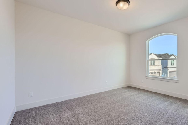 spare room with carpet floors and baseboards