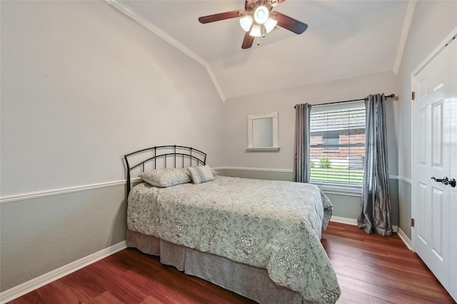 bedroom with vaulted ceiling, dark wood-type flooring, baseboards, a ceiling fan, and ornamental molding