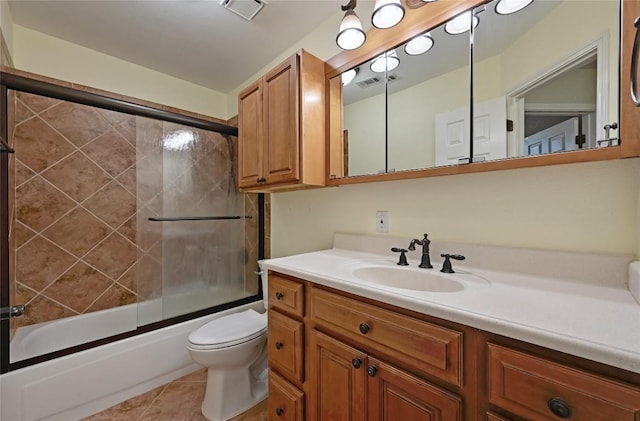 bathroom featuring shower / bath combination with glass door, vanity, toilet, and tile patterned flooring