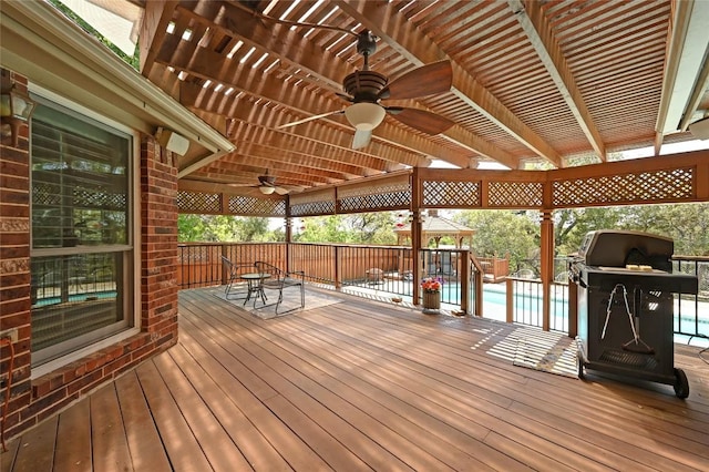 deck with a ceiling fan, a pergola, and outdoor dining space