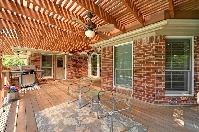 deck with ceiling fan, a pergola, grilling area, and outdoor dining space