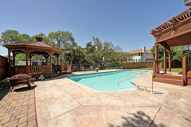 view of swimming pool featuring a gazebo, a fenced backyard, a patio area, and an outdoor fire pit