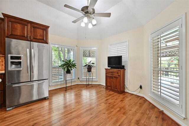 kitchen with stainless steel fridge, ceiling fan, light wood-style flooring, and baseboards