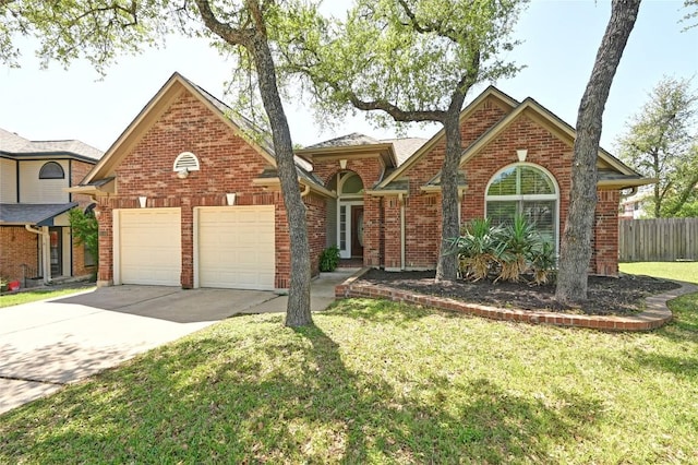 view of front of home featuring a garage, driveway, and brick siding