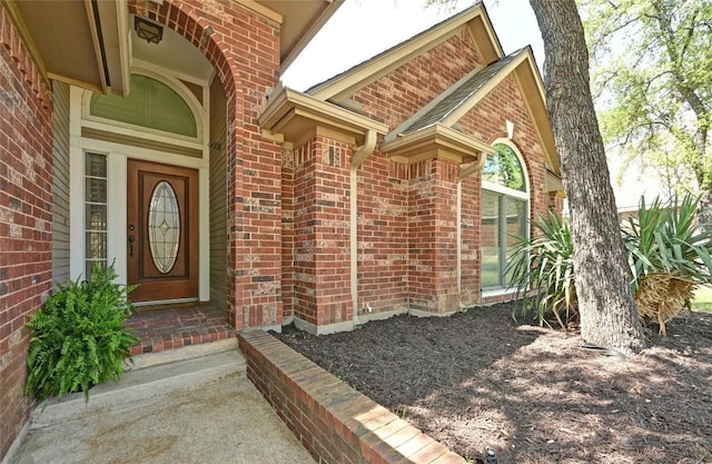 entrance to property featuring brick siding