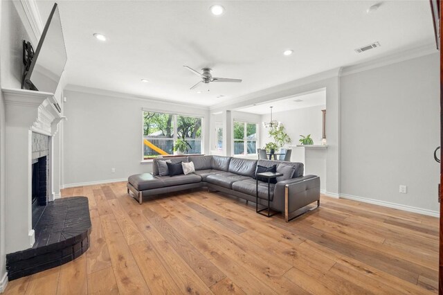 3420 Benecia Ct, Austin, TX 78738 - living area featuring a ceiling fan, a brick fireplace, ornamental molding, light wood finished floors, and recessed lighting