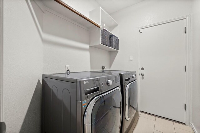 3420 Benecia Ct, Austin, TX 78738 - laundry area with separate washer and dryer and light tile patterned floors