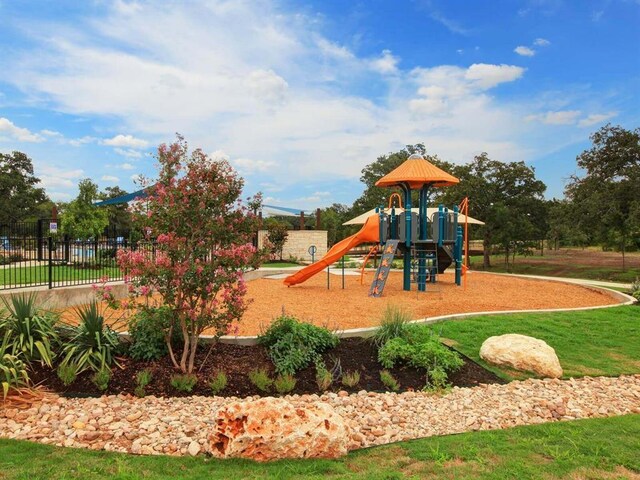 communal playground featuring fence