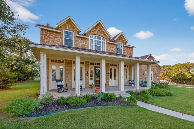 104 Double Cir, Burnet, TX 78611 - view of front of house featuring a porch, a front yard, french doors, and stone siding
