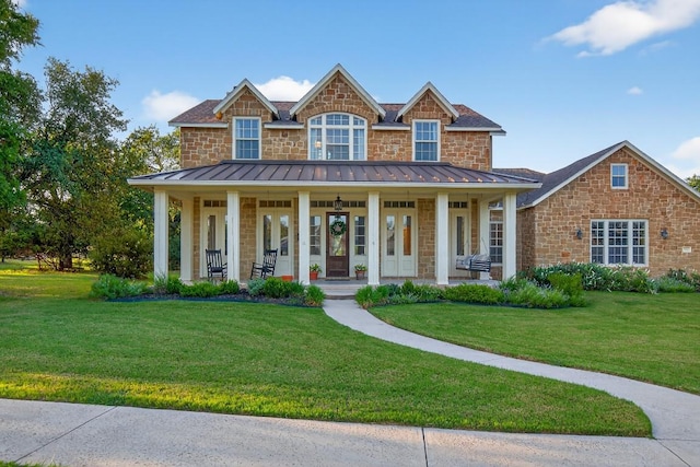 104 Double Cir, Burnet, TX 78611 - view of front facade with a porch, a front yard, a standing seam roof, and stone siding