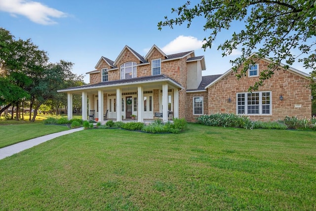 104 Double Cir, Burnet, TX 78611 - view of front facade featuring stone siding, covered porch, and a front lawn