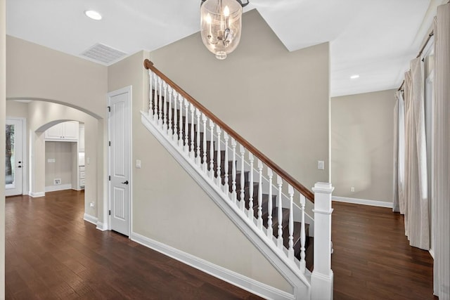 104 Double Cir, Burnet, TX 78611 - staircase featuring arched walkways, wood finished floors, and recessed lighting