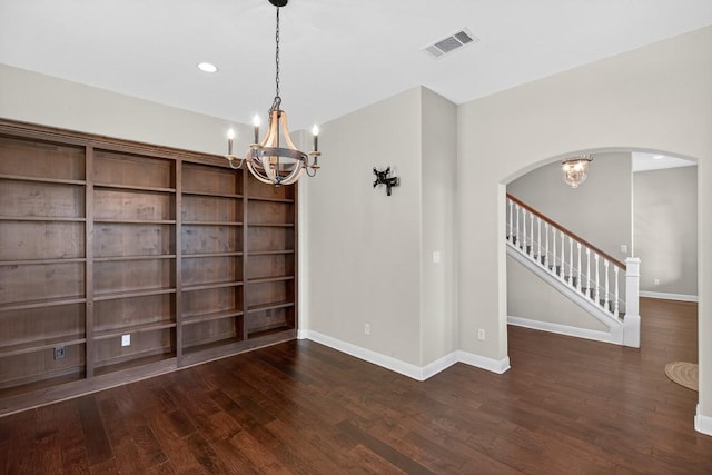 104 Double Cir, Burnet, TX 78611 - empty room featuring a chandelier, wood finished floors, arched walkways, stairs, and recessed lighting