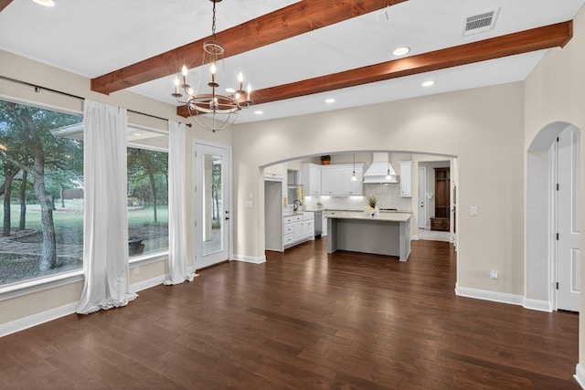 104 Double Cir, Burnet, TX 78611 - unfurnished living room featuring arched walkways, beamed ceiling, a chandelier, dark wood-style floors, and recessed lighting