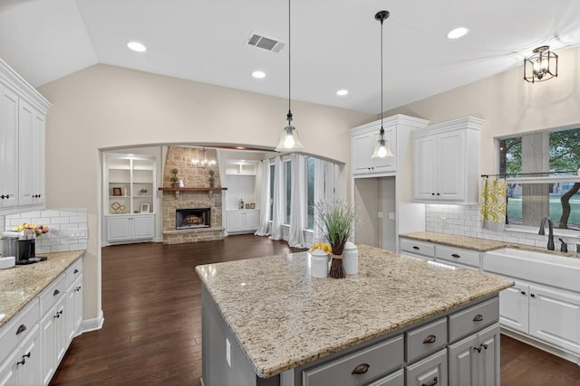 104 Double Cir, Burnet, TX 78611 - kitchen featuring gray cabinets, white cabinets, vaulted ceiling, decorative backsplash, and open floor plan