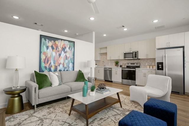6324 N Lamar Blvd Unit 313, Austin, TX 78752 - living area featuring light wood-type flooring, recessed lighting, and a ceiling fan
