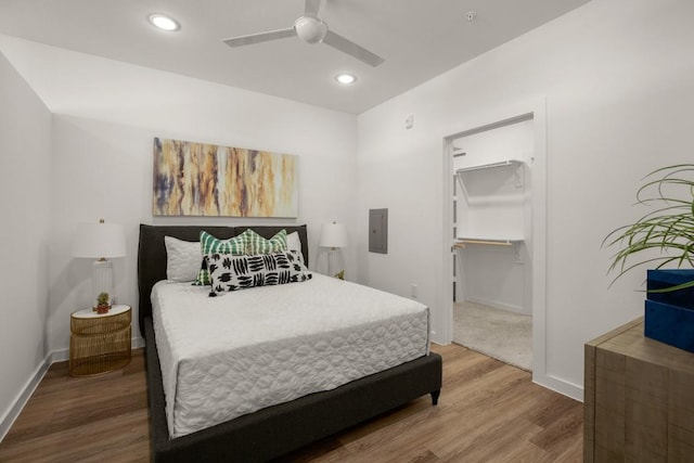 6324 N Lamar Blvd Unit 313, Austin, TX 78752 - bedroom featuring wood finished floors, recessed lighting, baseboards, a ceiling fan, and electric panel