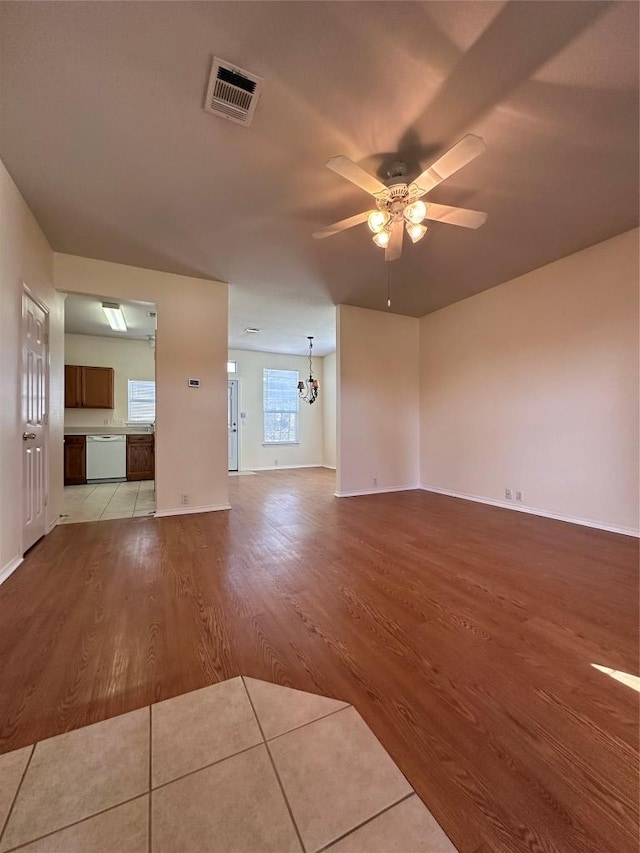 175A Michaelis Unit A, Kyle, TX 78640 - unfurnished living room featuring wood finished floors, a ceiling fan, and baseboards