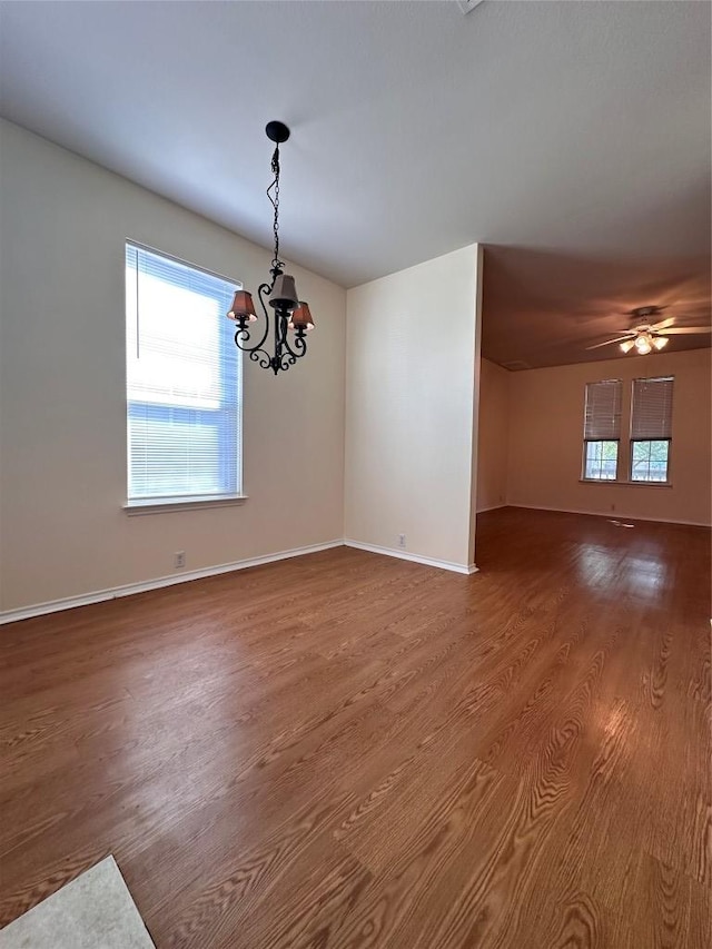 175A Michaelis Unit A, Kyle, TX 78640 - empty room with a chandelier, wood finished floors, healthy amount of natural light, and baseboards