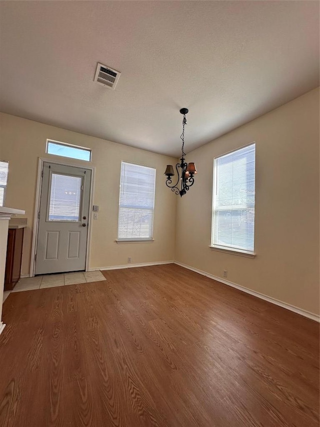 175A Michaelis Unit A, Kyle, TX 78640 - entrance foyer featuring a chandelier, light wood-style flooring, healthy amount of natural light, and baseboards