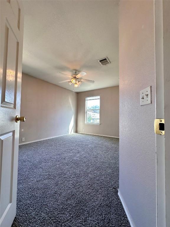 175A Michaelis Unit A, Kyle, TX 78640 - carpeted empty room featuring baseboards and ceiling fan