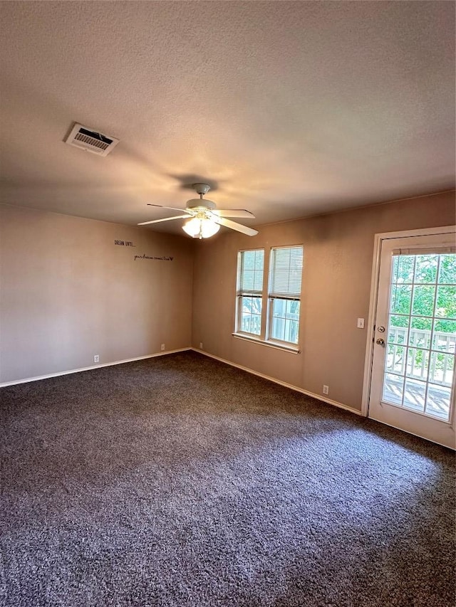175A Michaelis Unit A, Kyle, TX 78640 - spare room featuring ceiling fan, dark carpet, a textured ceiling, and baseboards
