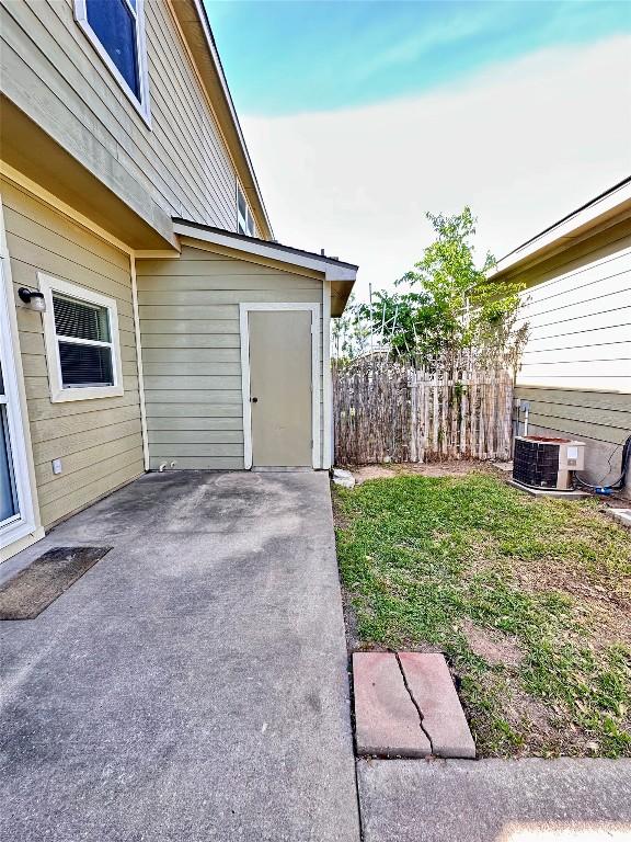 175A Michaelis Unit A, Kyle, TX 78640 - view of yard with cooling unit and a patio area