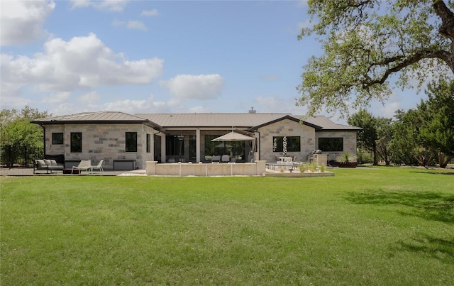 7817 Orisha Dr, Austin, TX 78739 - back of property featuring a patio, stone siding, a standing seam roof, metal roof, and a lawn