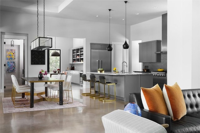 7817 Orisha Dr, Austin, TX 78739 - kitchen featuring a towering ceiling, light countertops, built in fridge, modern cabinets, and decorative backsplash